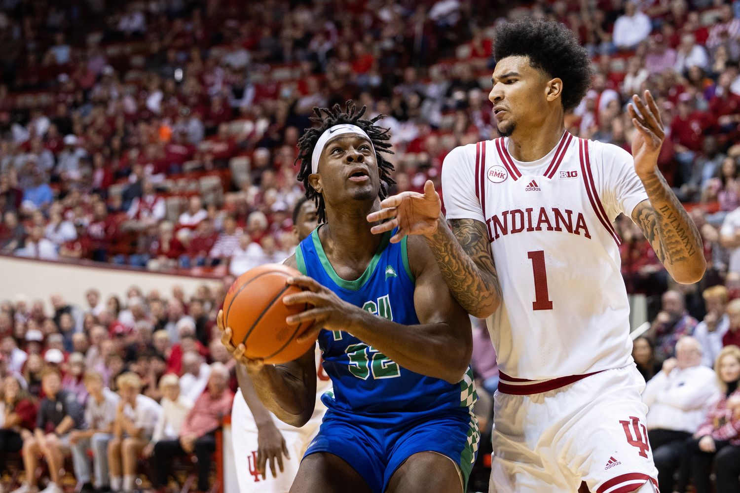 Nov 7, 2023; Bloomington, Indiana, USA; Florida Gulf Coast Eagles forward Keeshawn Kellman (32) drives against Indiana Hoosiers center Kel'el Ware (1) in the second half at Simon Skjodt Assembly Hall. Mandatory Credit: Trevor Ruszkowski-USA TODAY Sports